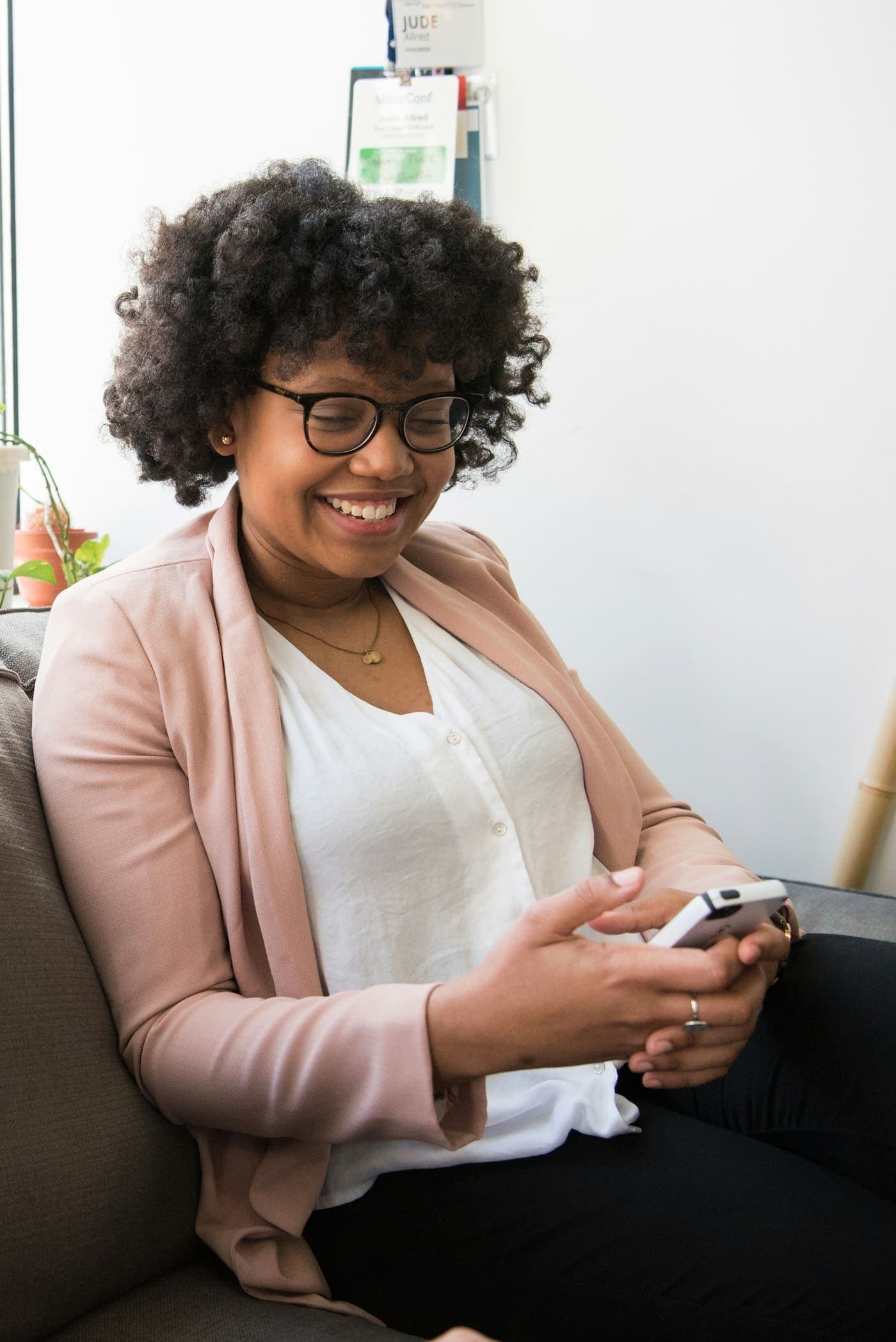 A smiling woman holding her phone