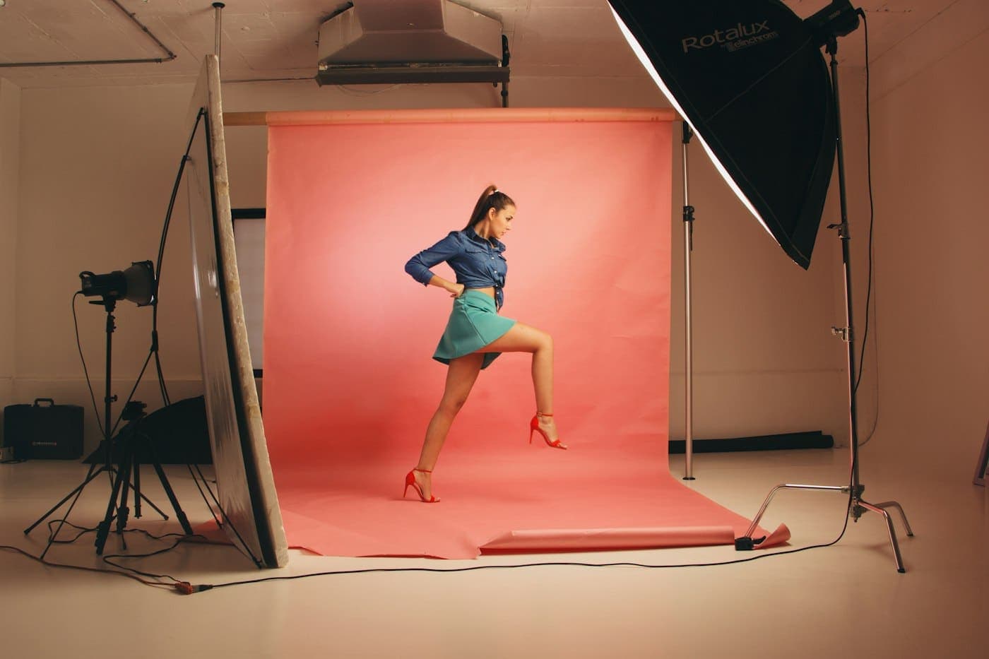 A model posing on a coral studio set